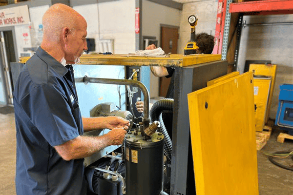 Technician Maintaining Air Compressor System for Good Health